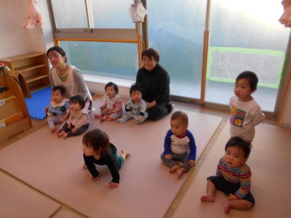 0歳児のハンドベル演奏を聴く様子